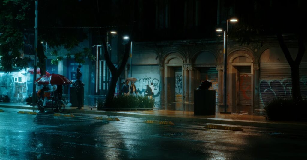 夜間に傘を差して片手運転をする自転車のイラスト。無灯火や傘さし運転の危険性を表現。