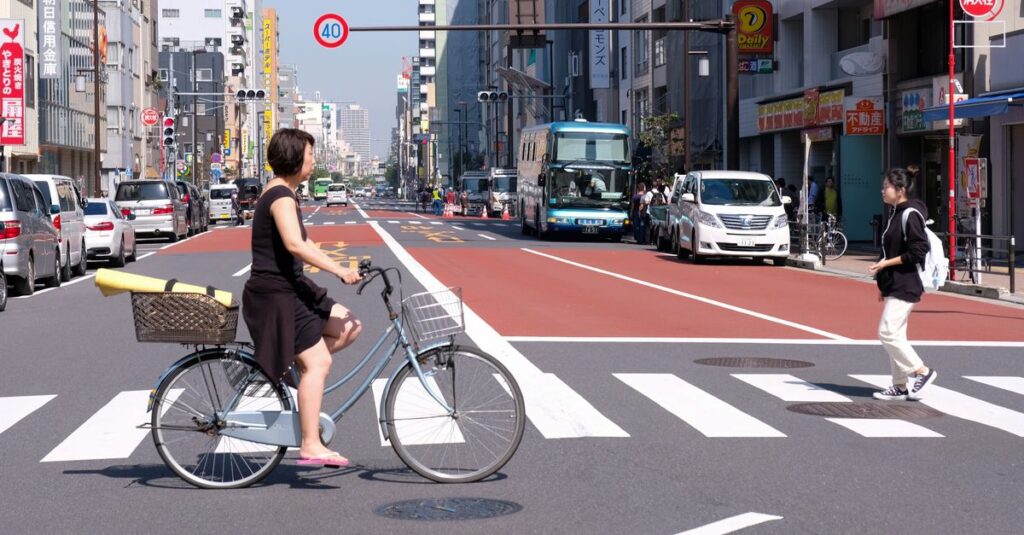自転車違反が増える社会的背景として都市交通や配達需要を説明するイメージ図
